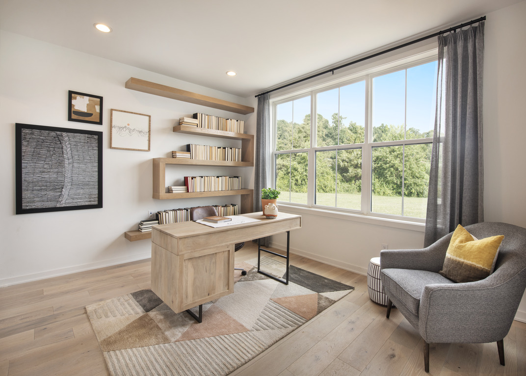 Home office with geometric shelving and light brown desk
