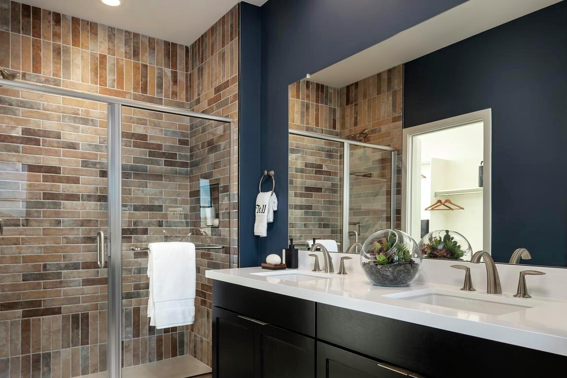 Bathroom highlighted by tile that resembles exposed brick