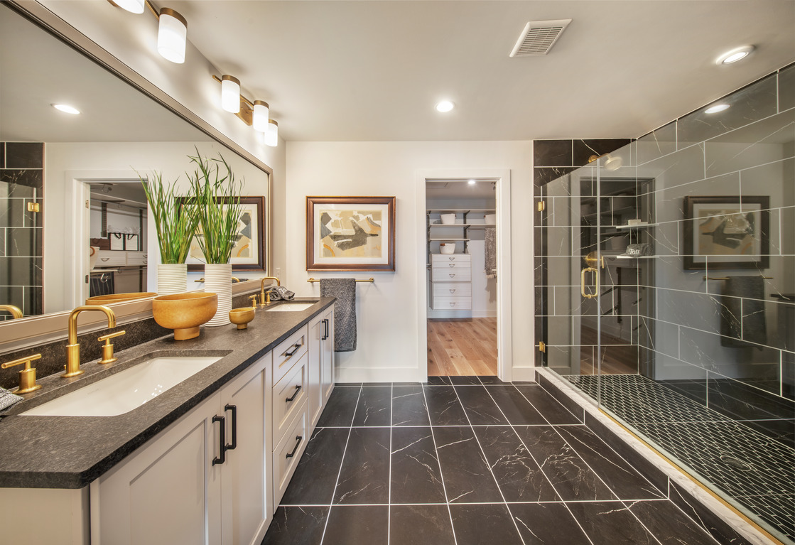 Luxe bathroom featuring black tile and metallic accents