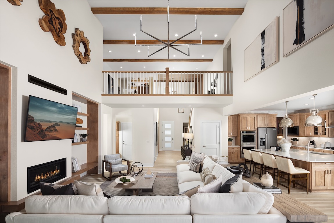 two-story great room with wood beamed ceilings