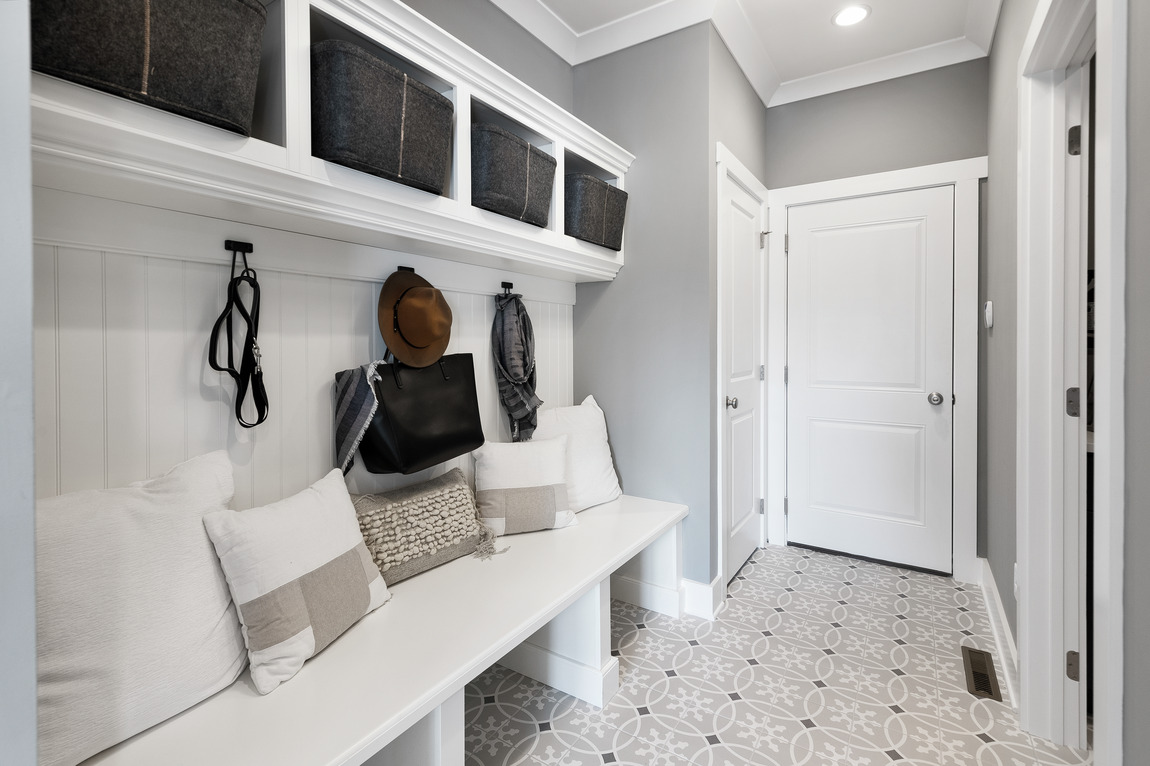 Calming white mudroom design