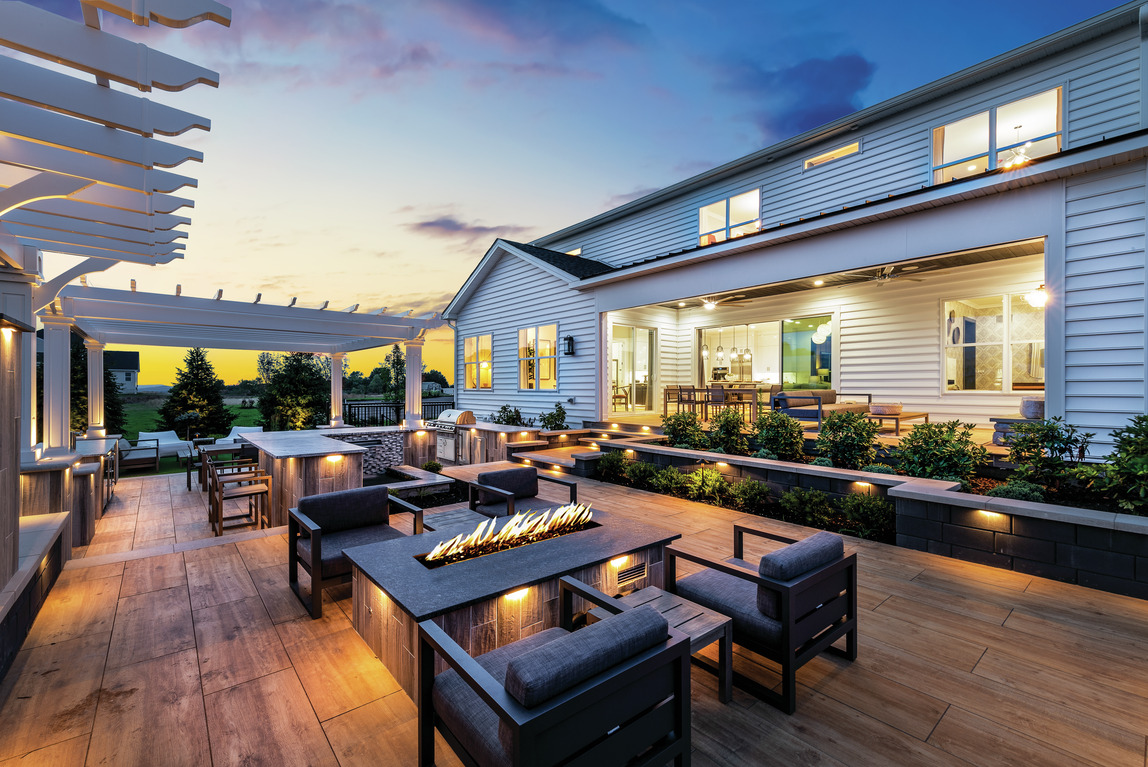 Expansive patio design featuring ample hardscape lighting and fire pit