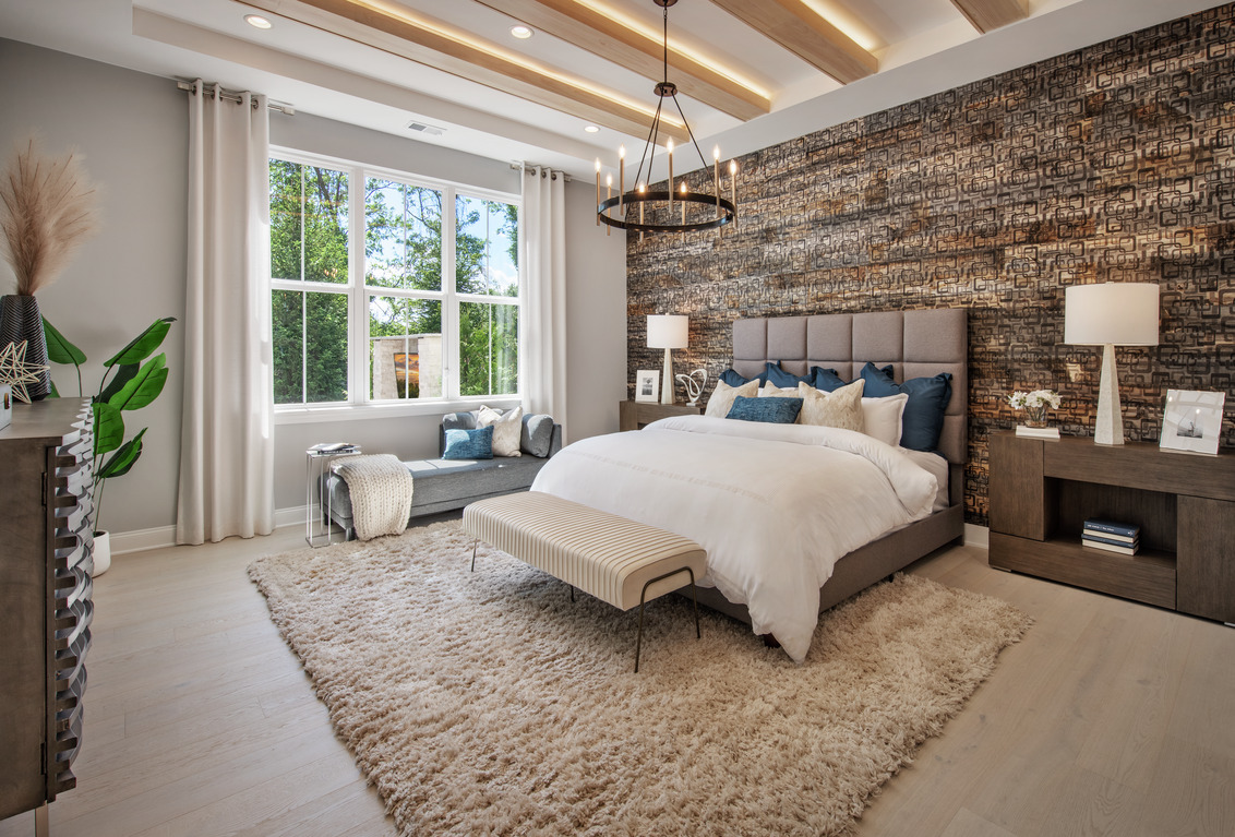 Cozy bedroom with area rug, natural lighting, and neutral colors