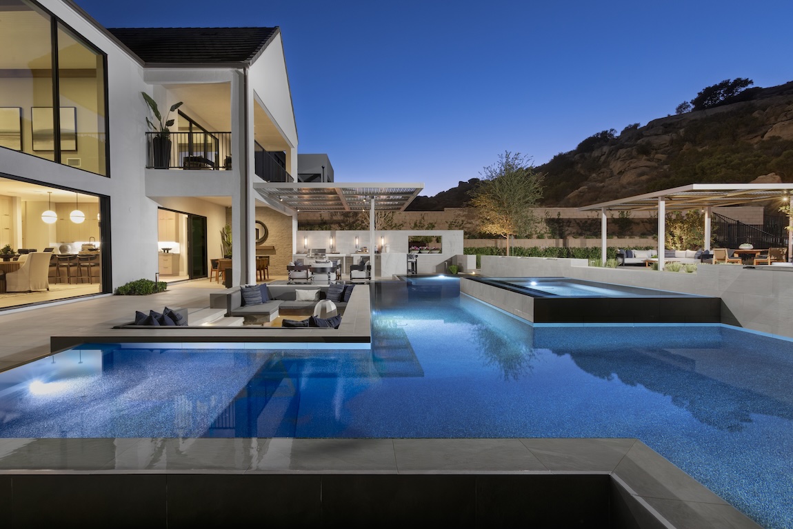 private outdoor pool with outdoor lighting and lounge areas
