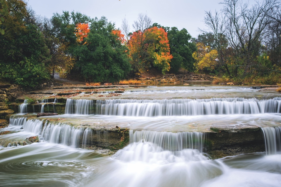 scenic photo of waterfall and colorful foliage