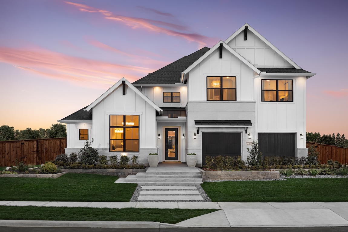 exterior of modern farmhouse with a sunset backdrop