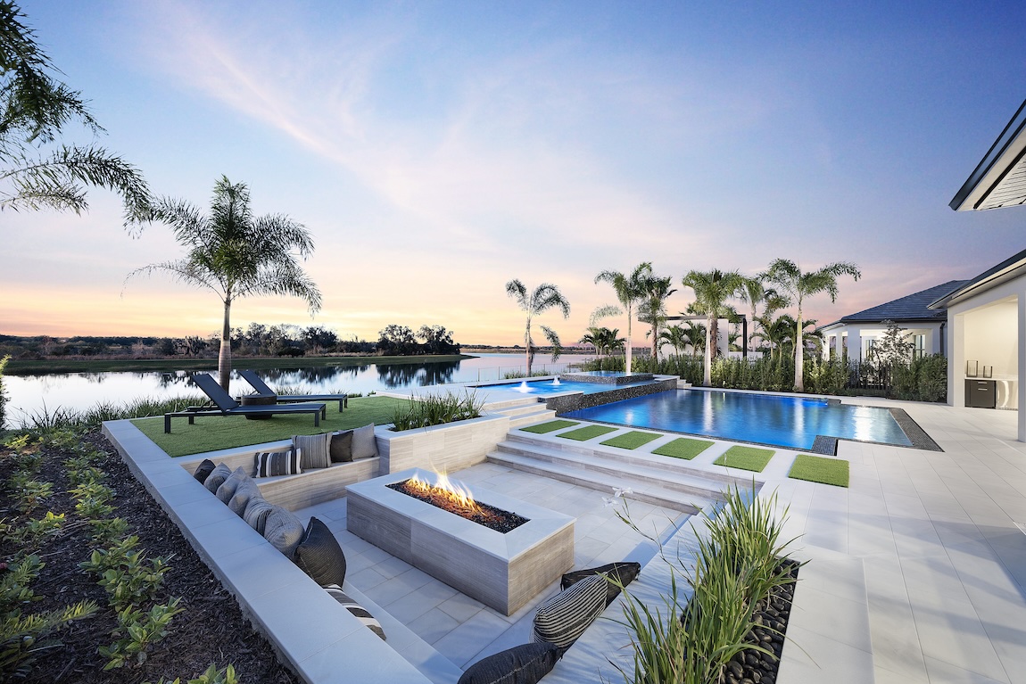outdoor pool overlooking the water and palm trees