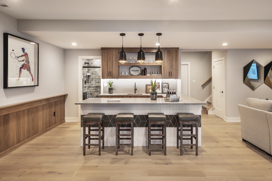 Basement with full bar, black accent lighting, and white countertop