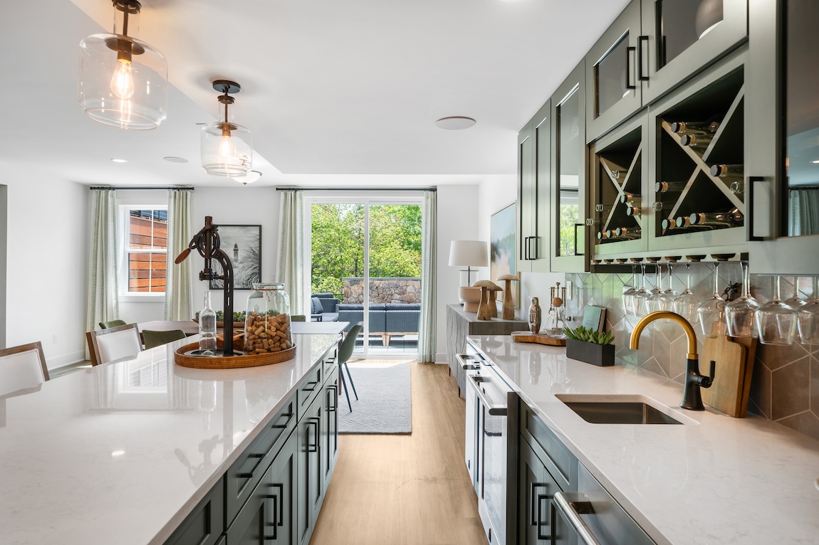Home bar with green cabinets 