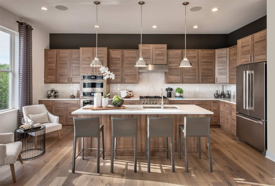 Kitchen design featuring natural woods for its cabinetry, island, and flooring