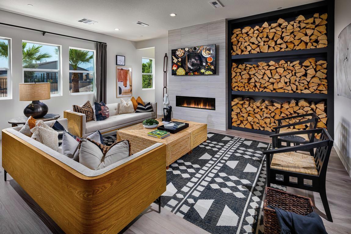 great room highlighted by central fireplace, wood decor, and light color palette