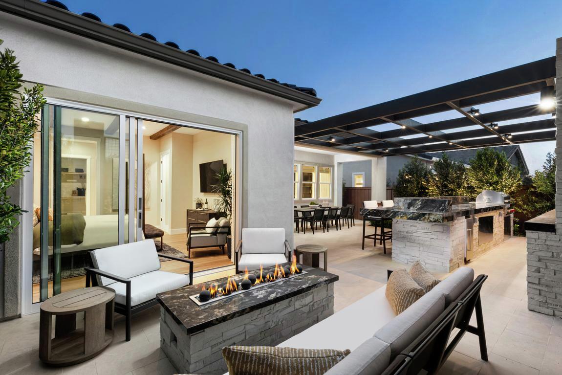 luxe modern outdoor living design highlighted by fire pit and kitchen