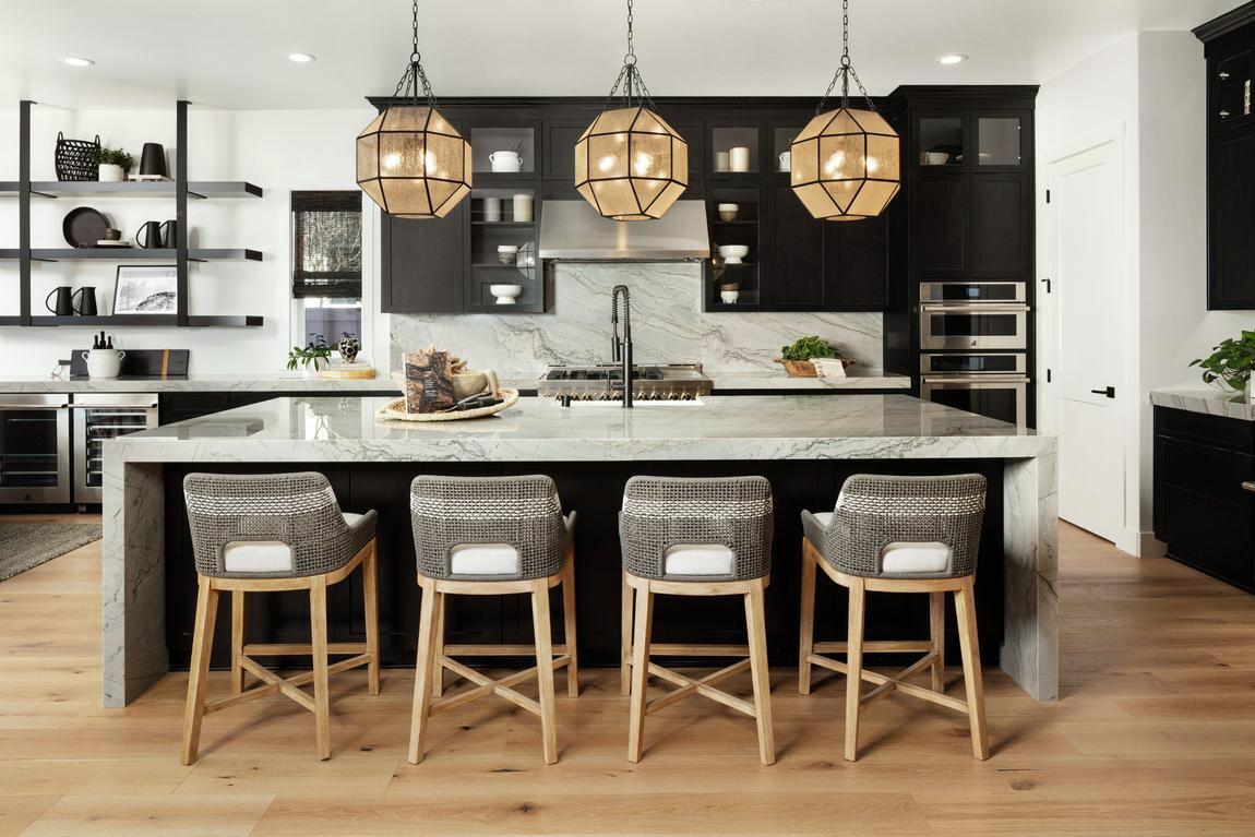 dark kitchen design highlighted by stunning pendant lighting