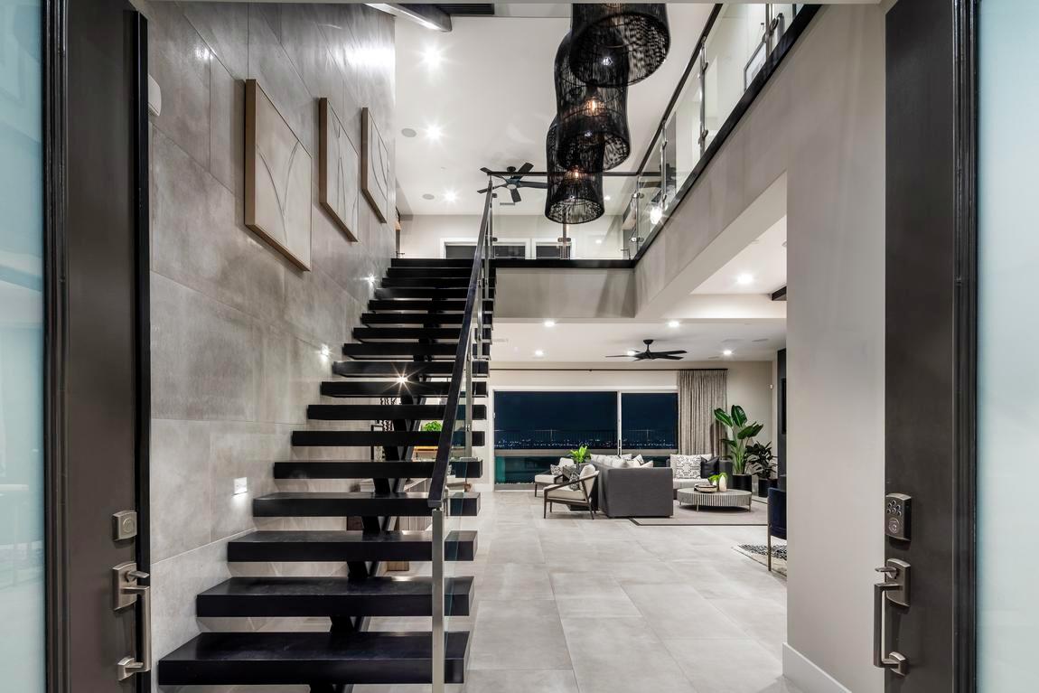 Floating contemporary staircase within monotone interior design