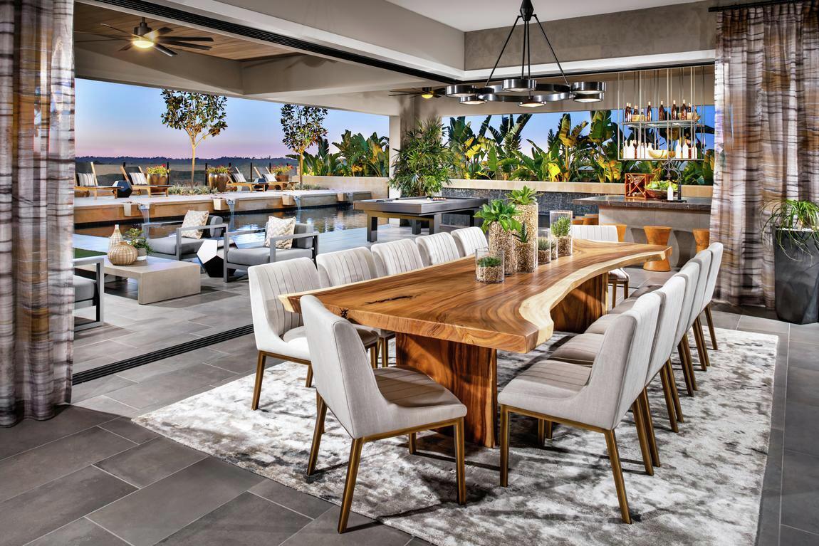 Luxurious dining room with marvelous wood table paired with outdoor transition 