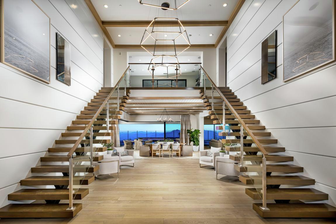 Coastal contemporary dual staircase, shiplap walls, and metallic accents 