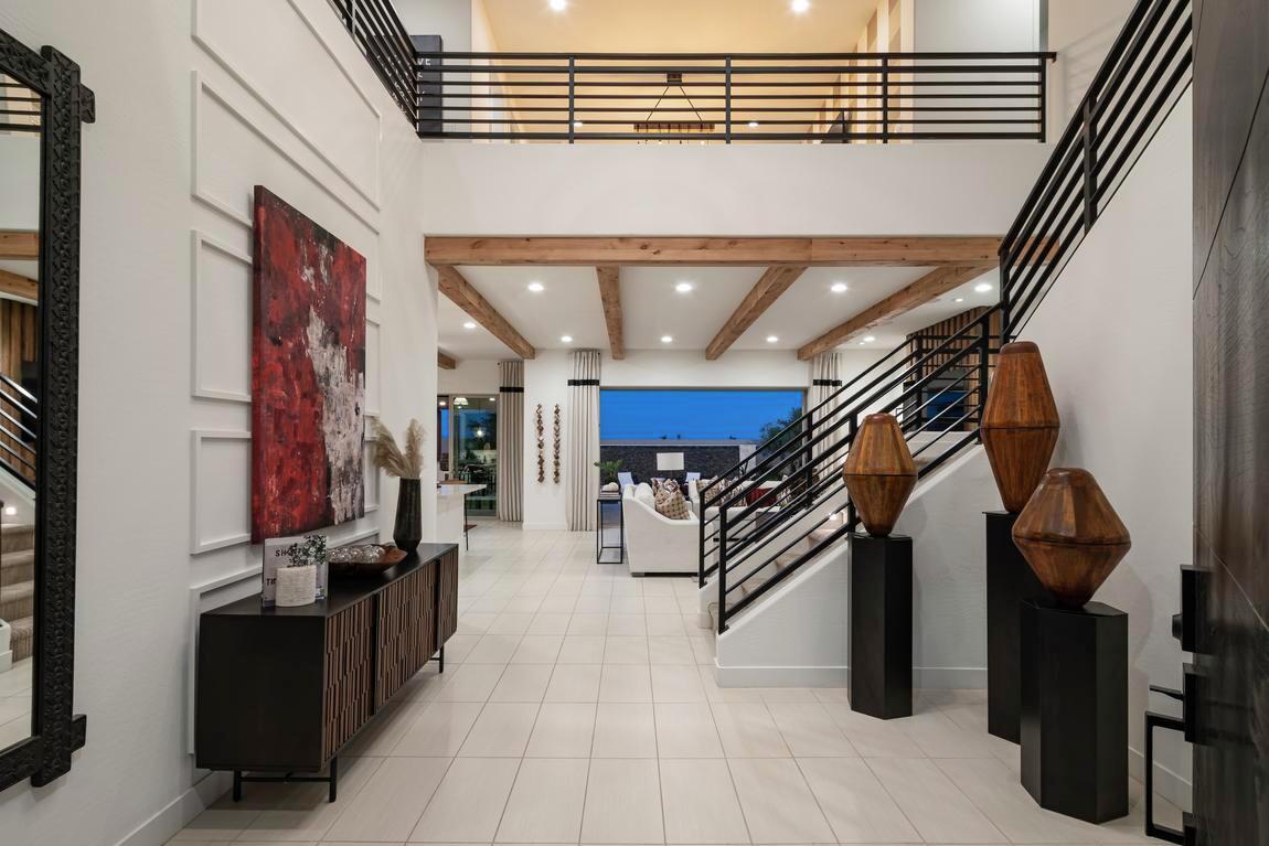 Foyer design with view of the home's first floor including outdoor transition from the great room to the backyard