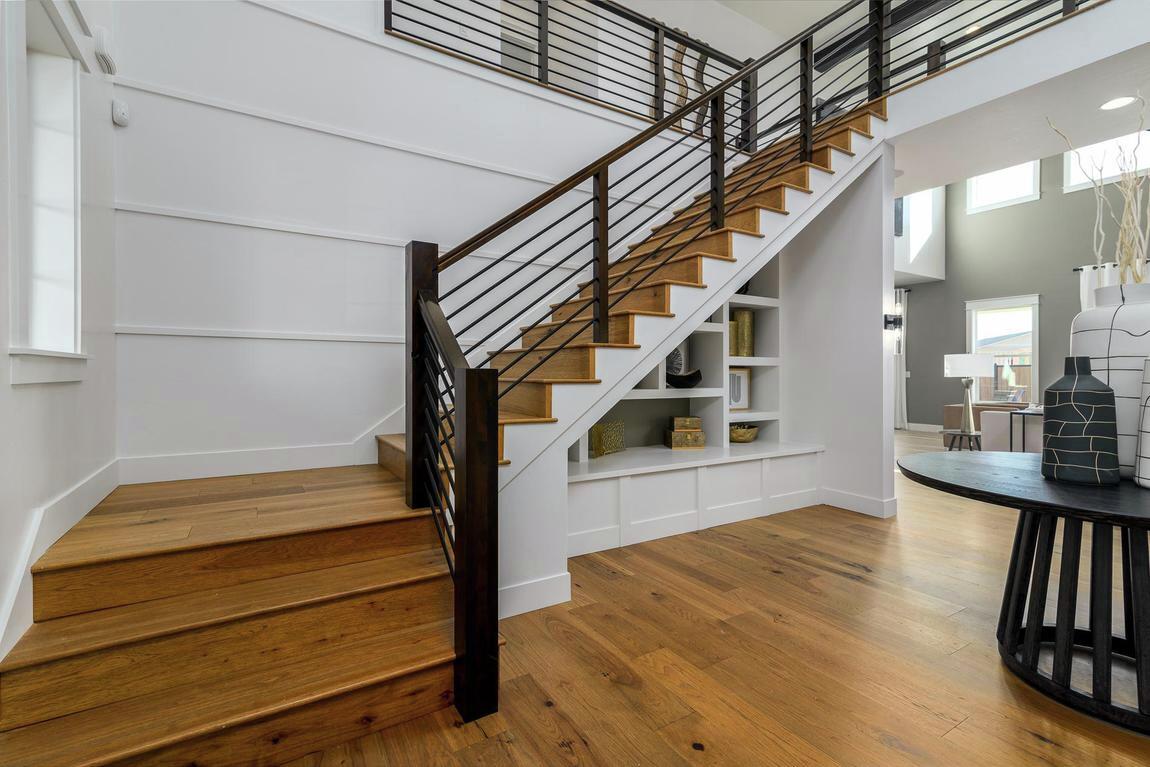 Foyer highlighted by innovative staircase with built-in shelving