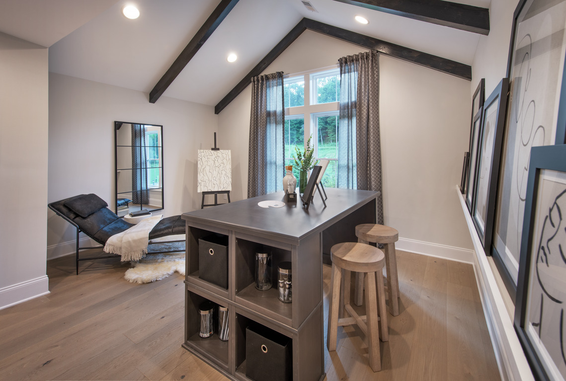 Craft space highlighted by vaulted ceiling and wood beam accents