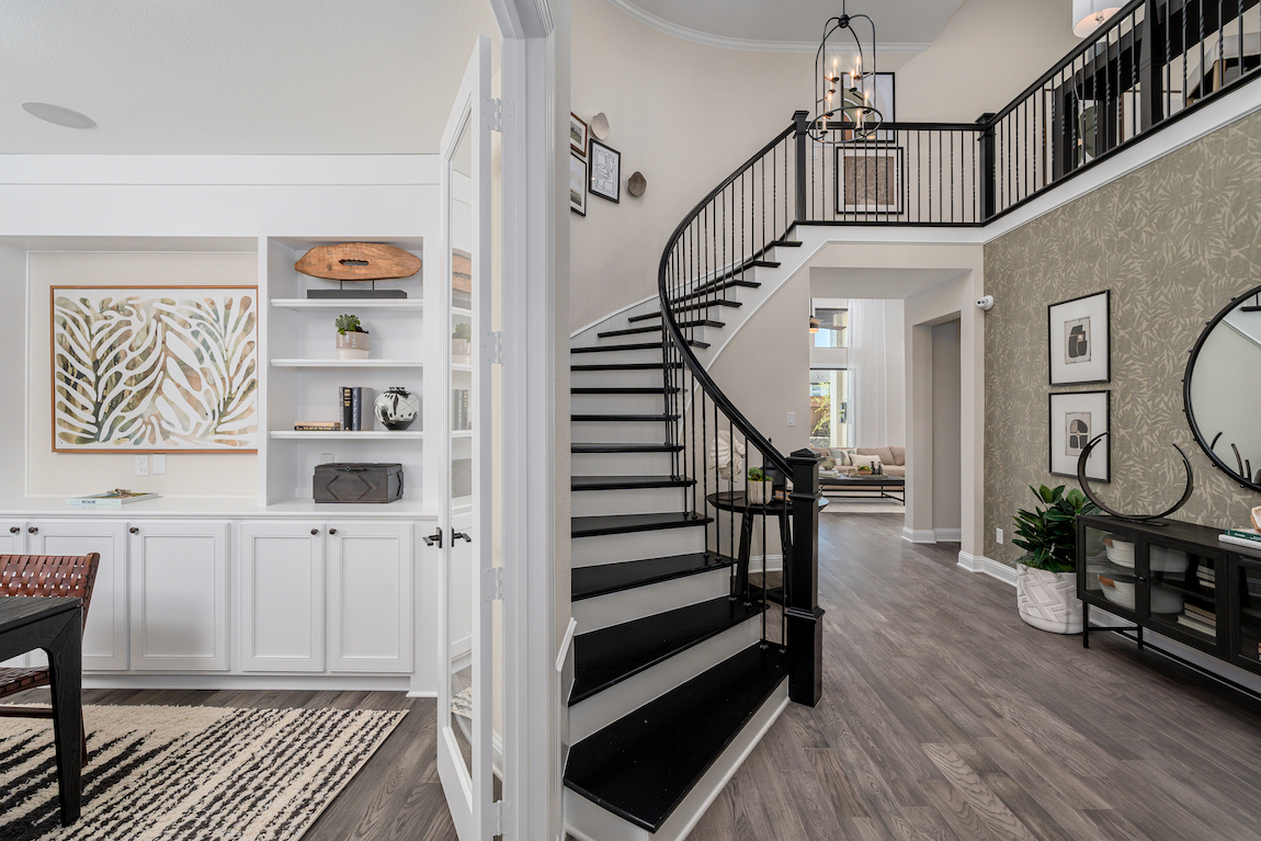 foyer including curved staircase and adjacent home office space