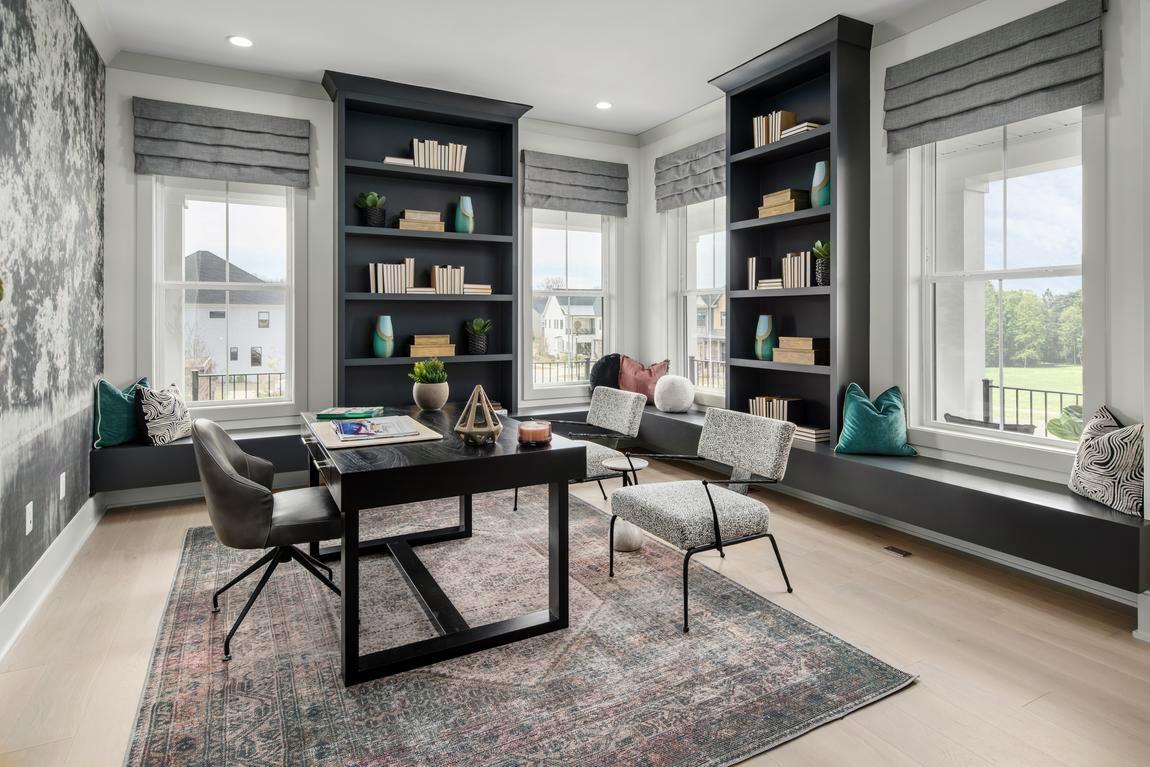 Spacious home office with a light, airy feel and expansive bookcase shelving