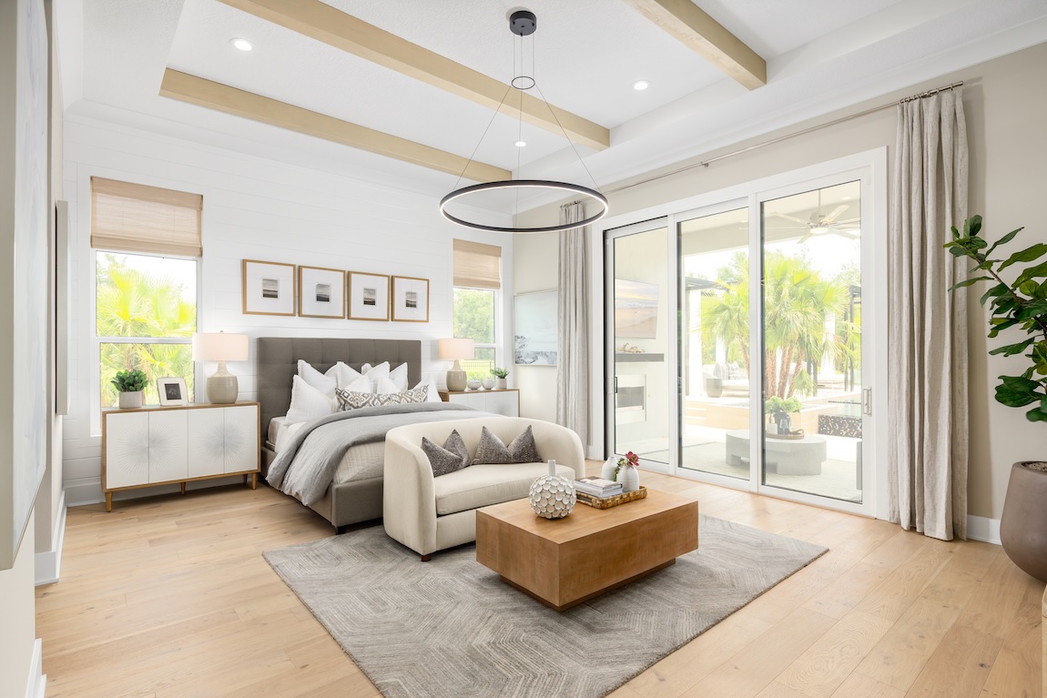 primary bedroom with glass sliding doors to the outdoor living space