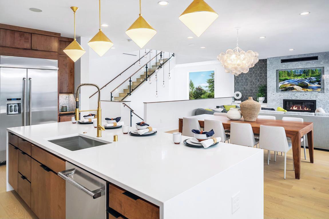 Light, airy contemporary interior design highlighted by pendant lighting and white walls