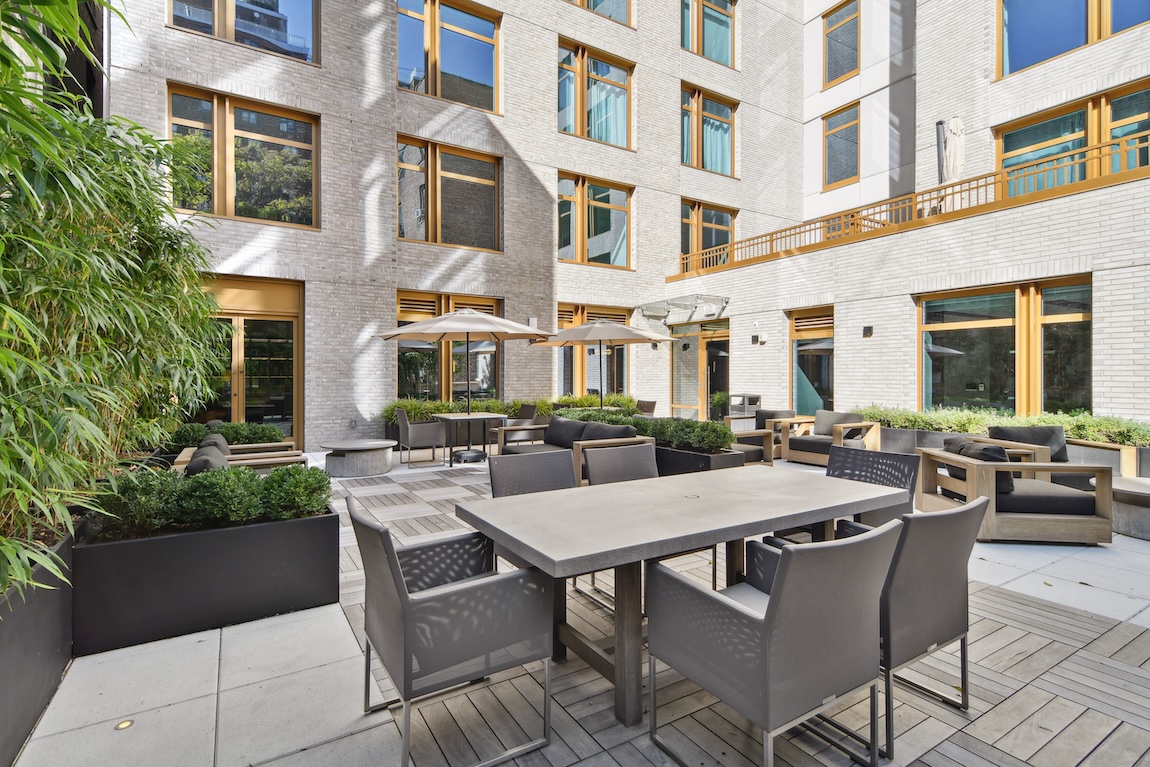 amenity rooftop with seating and umbrellas