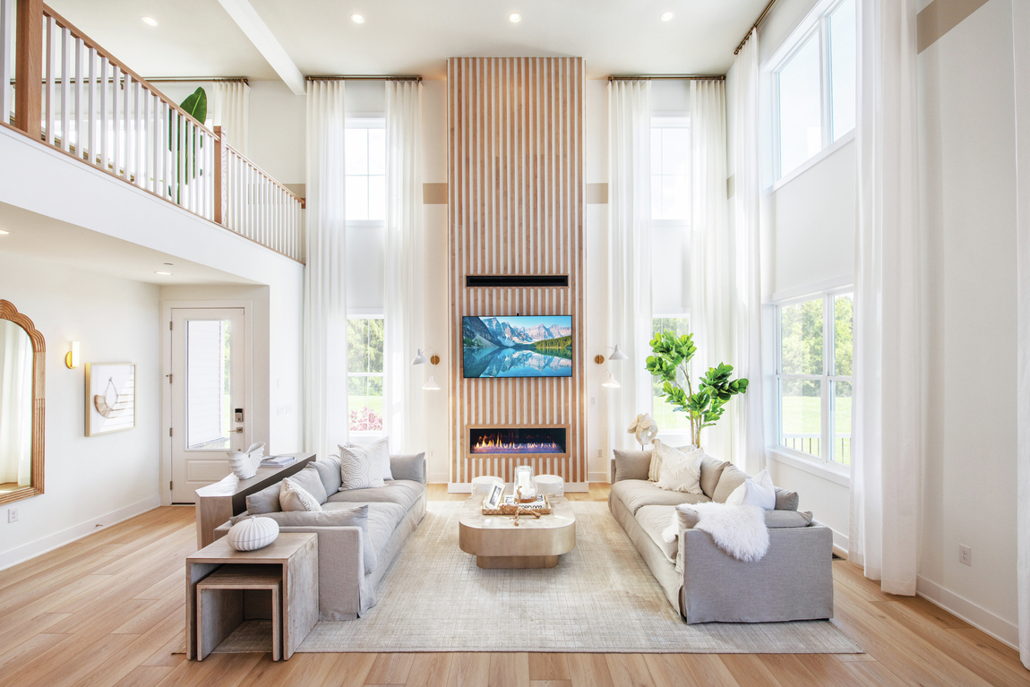 Bright, naturally lit great room highlighted by gorgeous fireplace accent wall