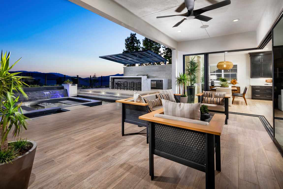 Indoor-outdoor seating area on porch by dining room and modern pool space