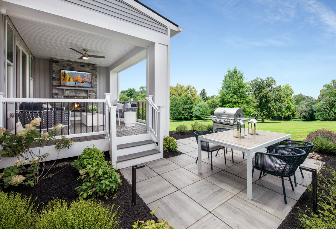 Covered patio with an entertainment space and backyard deck