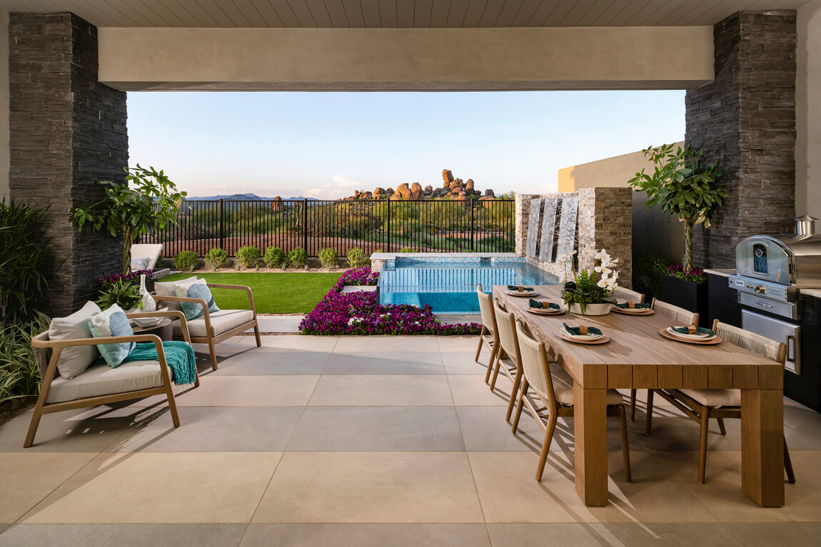 Indoor-outdoor dining area with a nearby pool 