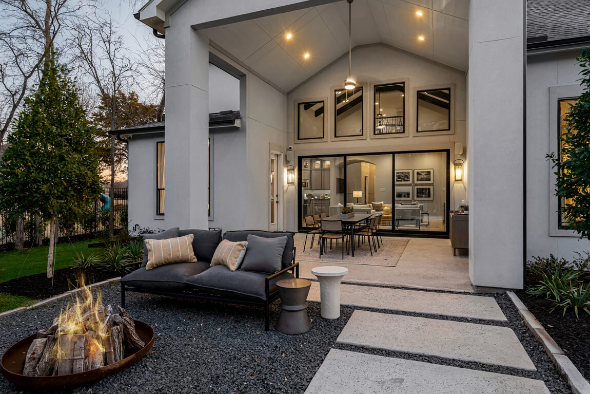 Indoor outdoor patio design with tall ceilings and modern seating areas