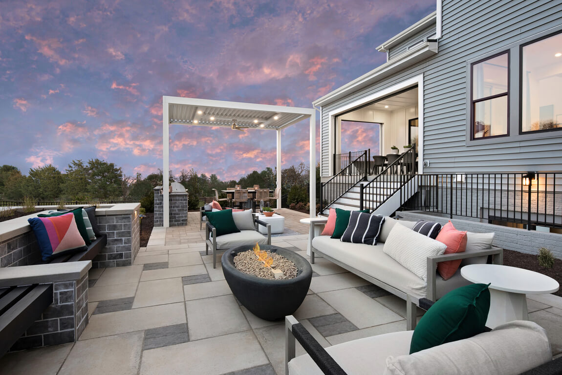 patio with an outdoor kitchen, dining area, and fire pit