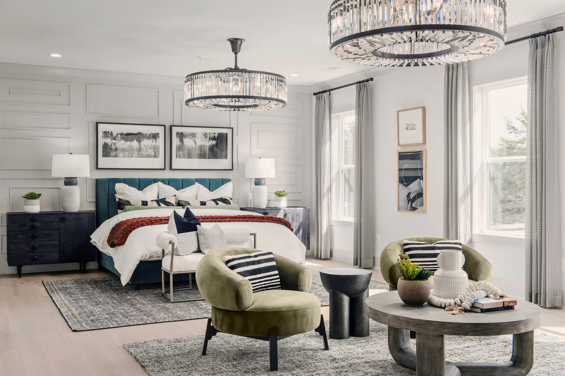 Elegant primary bedroom elevated by dual chandeliers