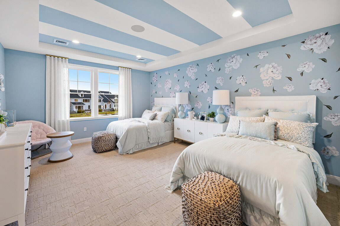 Light, airy kids bedroom featuring light blue color scheme and floral wallpaper design
