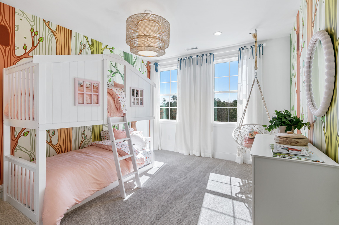 Playful kids bedroom with a jungle theme highlighted by whimsical tree wallpaper design