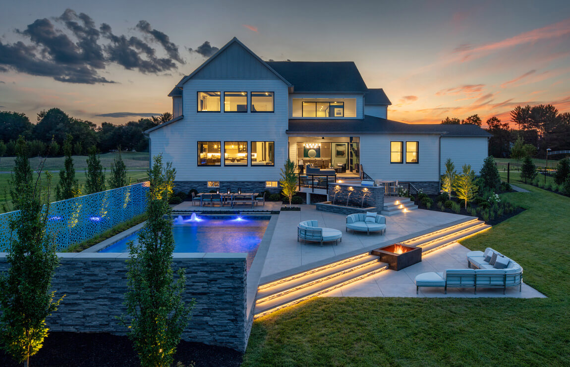 Modern luxury backyard featuring stunning outdoor lighting