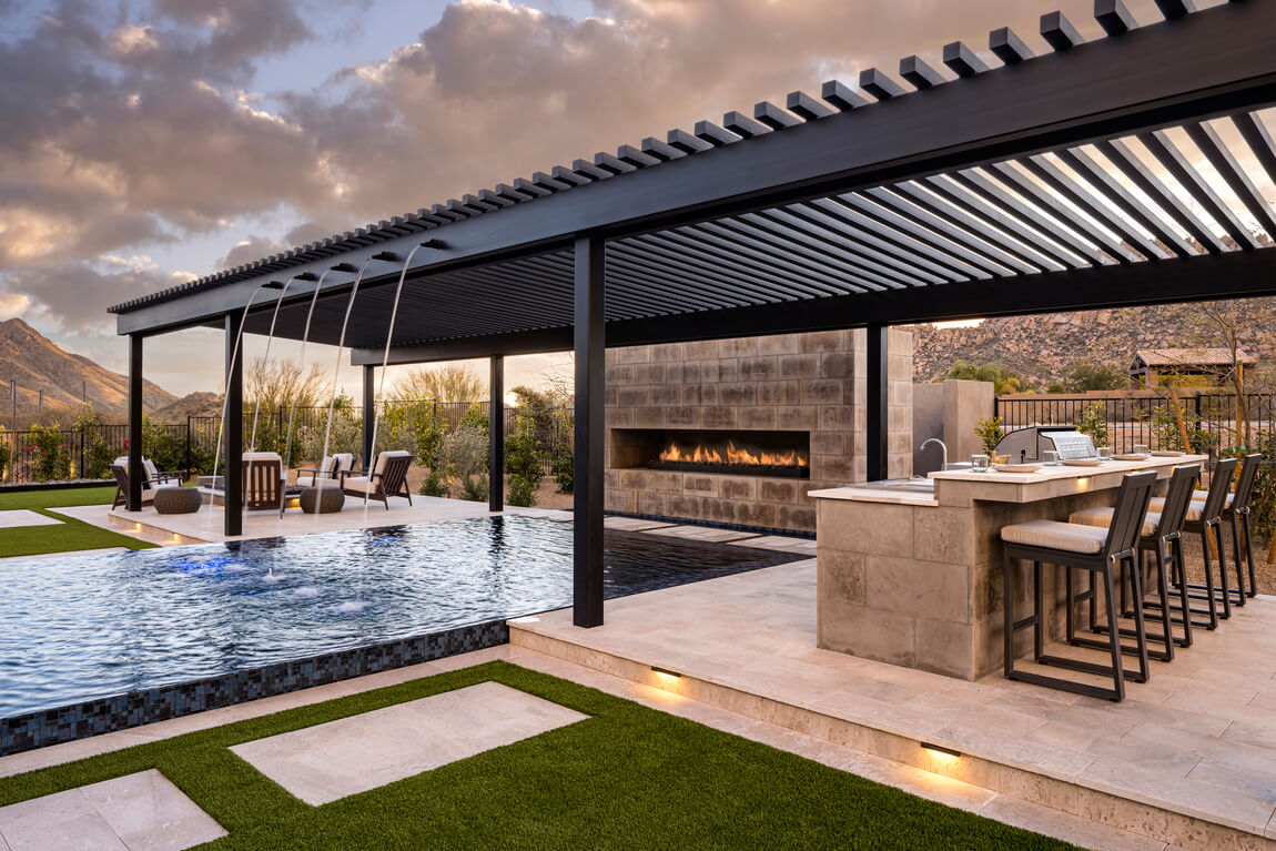 Luxe backyard architecture highlighted by a collection of landscaping ideas, including gazebo, pool, fireplace, and outdoor kitchen