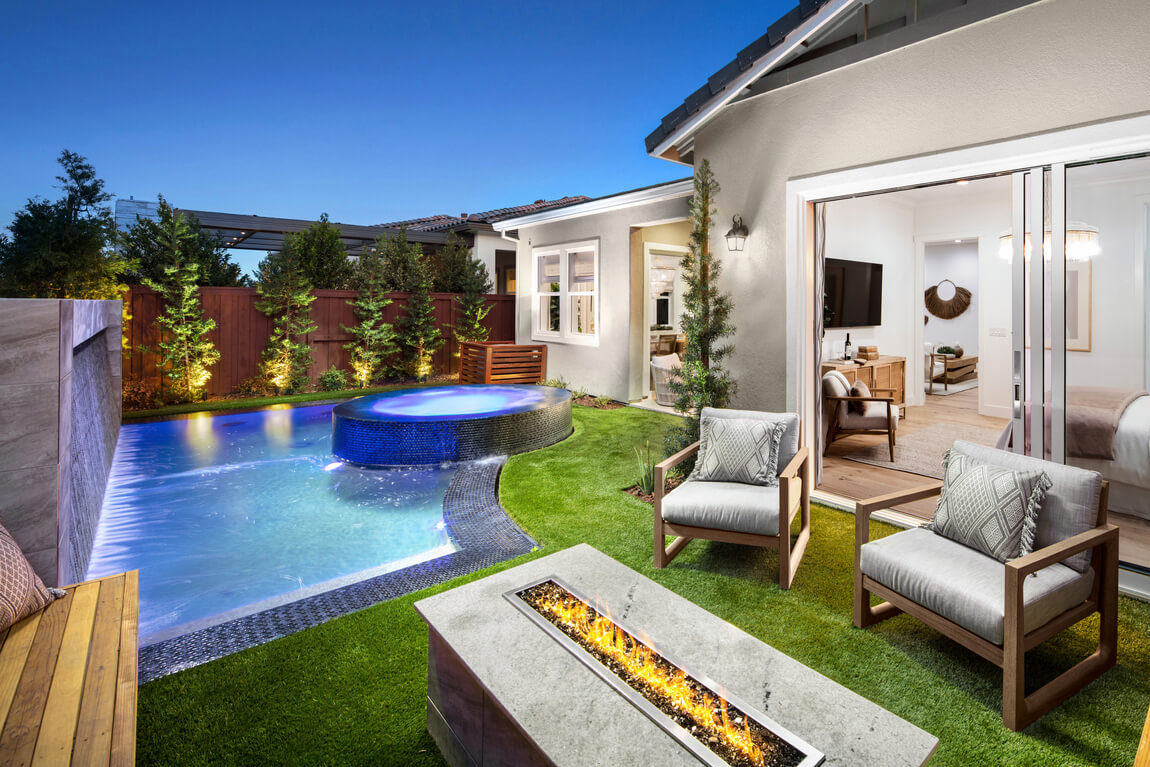 Luxe backyard design with pool and fire pit at Regency at Folsom