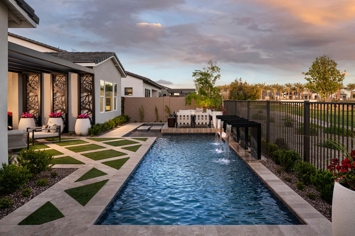 Luxe backyard design with pool featuring waterfall spots and floating lounge area