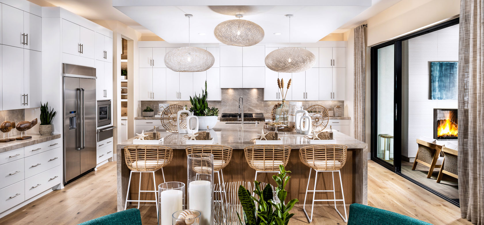 Regency at Folsom Ranch kitchen with island chairs and indoor to outdoor living entrance