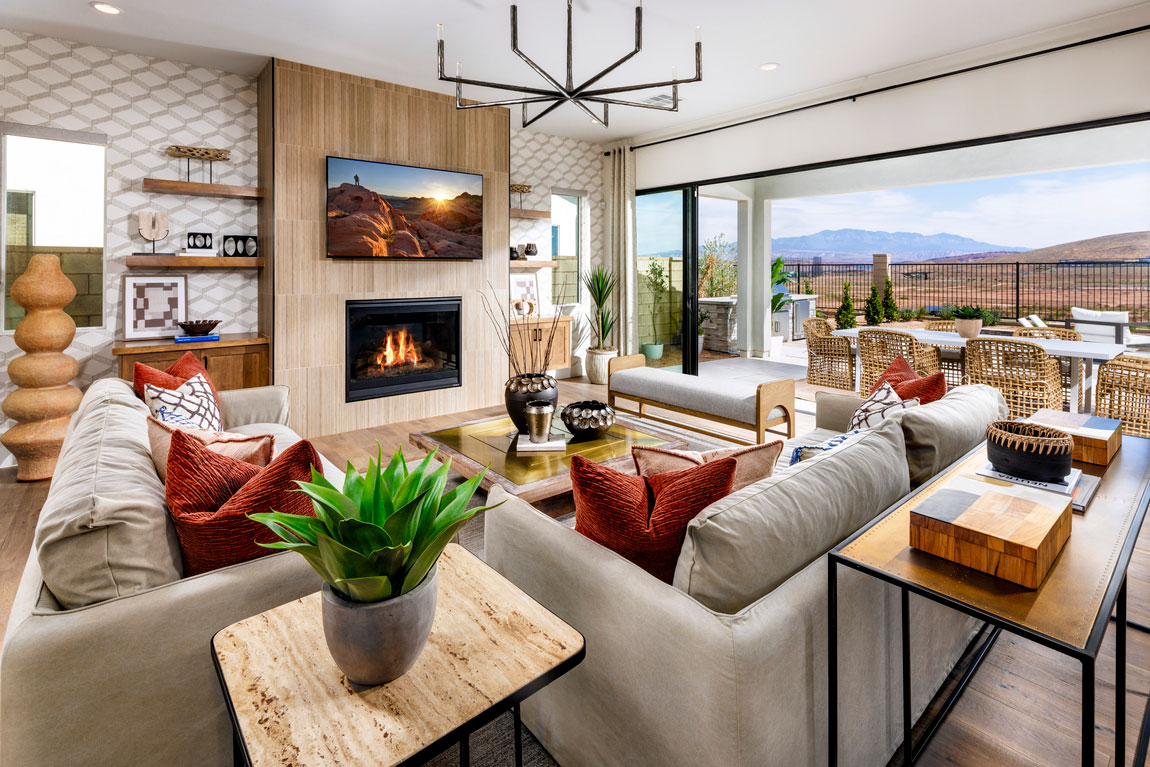 Living room with tv above fireplace with indoor to outdoor living space.
