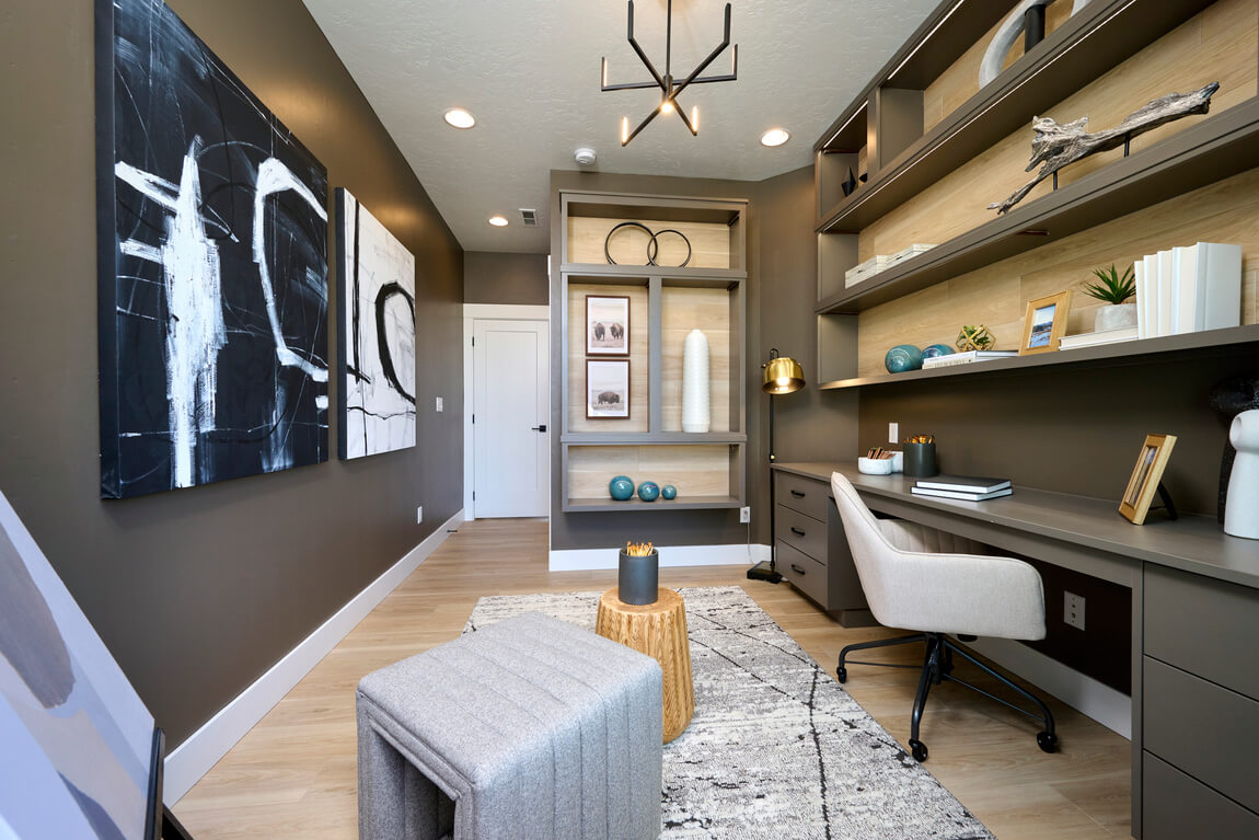 Modern family office with brown shelving and bold artwork