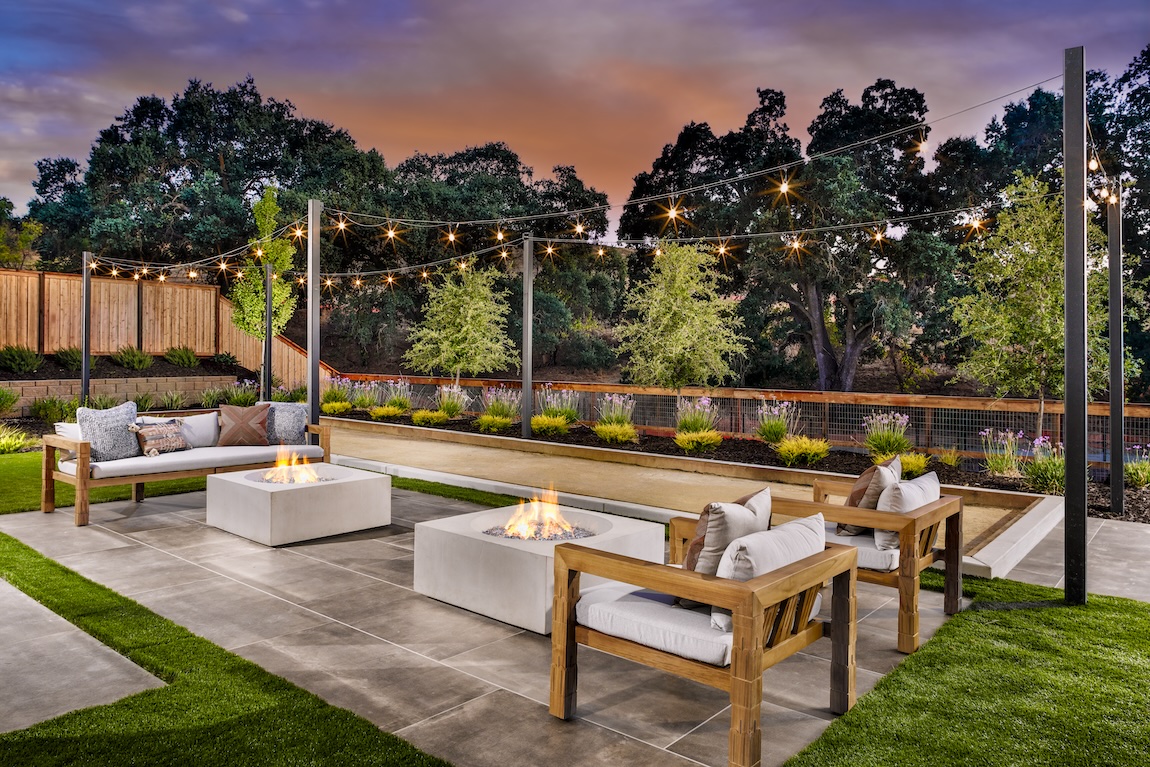 outdoor fire pit lounge with overhead string lights