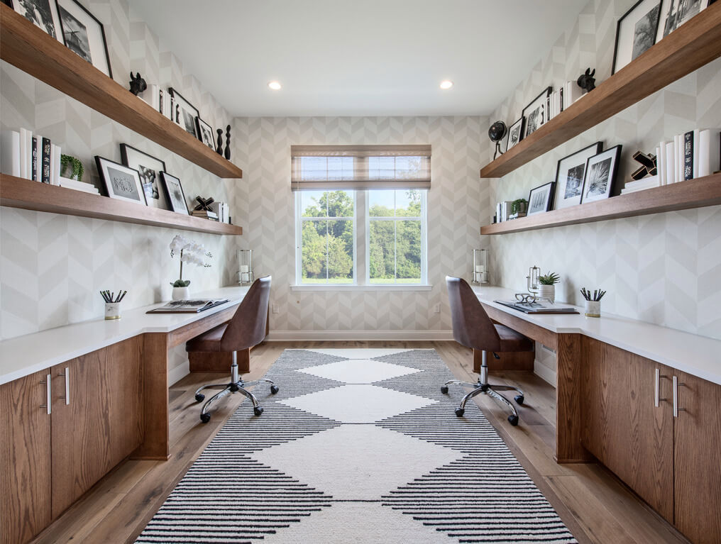 Shared home office layout with dual desks and chevron wallpaper