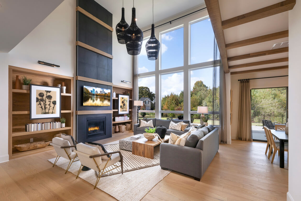 spacious great room with ample natural lighting stemming from two-story window design