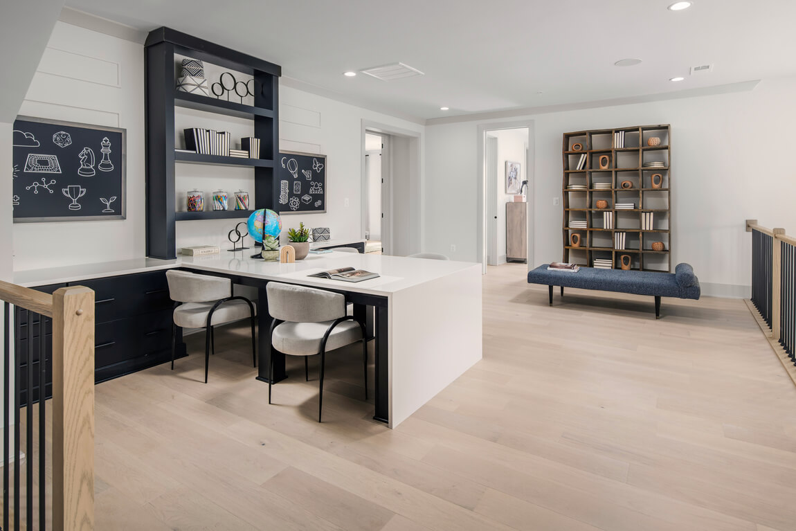 Childrens shared workspace with chalkboard decor and multiple book shelves