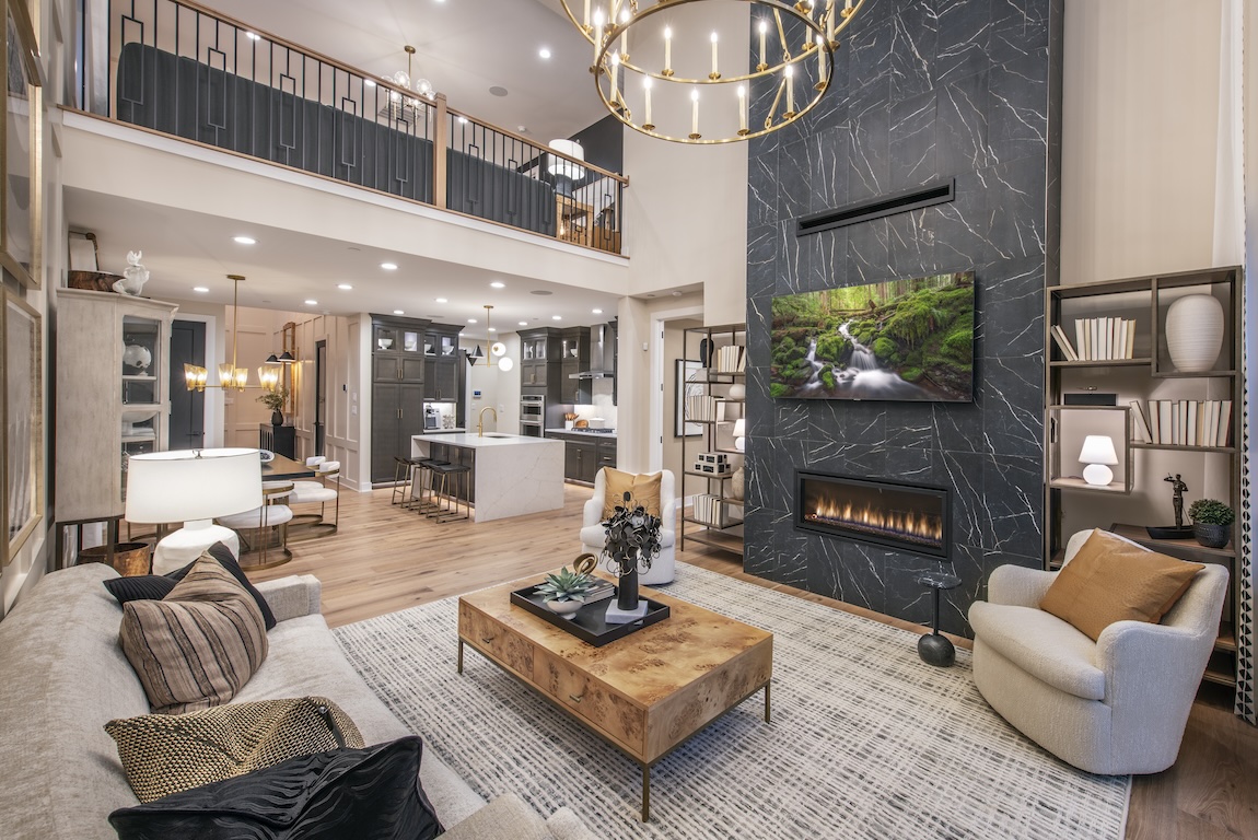 Two-story great room featuring textured fireplace wall design