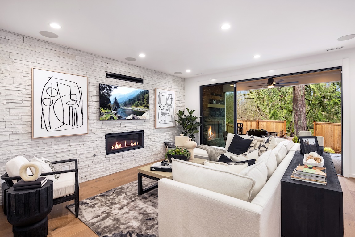 modern great room with stone fireplace in quick move-in home in Washington